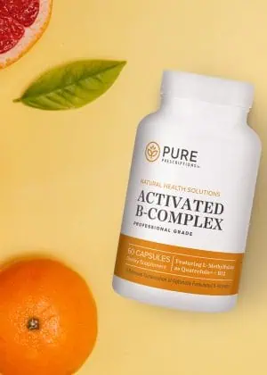 Activated B-Complex flat lay against oranges and grapefruits.