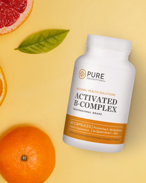 Activated B-Complex flat lay against oranges and grapefruits.