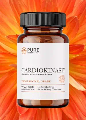 Bottle of Cardiokinase in front of an opened flower.