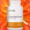 Bottle of Cardiokinase in front of an opened flower.