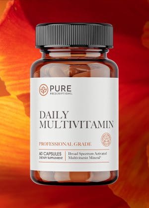 Bottle of Daily Multivitamin against a flower.