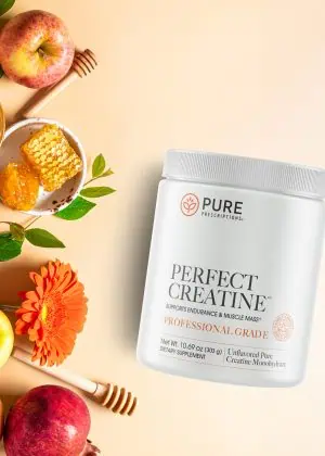 Perfect Creatine flatlay against flowers, apples and honeycomb.