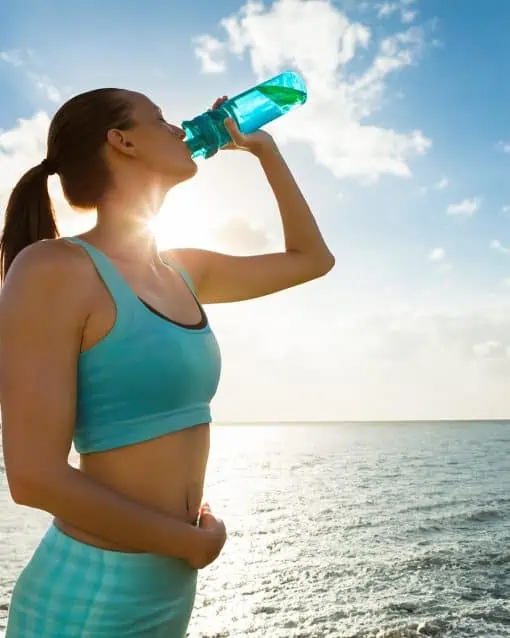 Healthy woman drinking electrolytes.