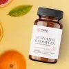 Pure Prescriptions Activated B-Complex bottle in a citrus flatlay with grapefruit, orange, and lemon leaf on a soft yellow background