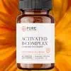 Pure Prescriptions Activated B-Complex bottle on vibrant orange flower background, showcasing the full spectrum B-vitamin supplement